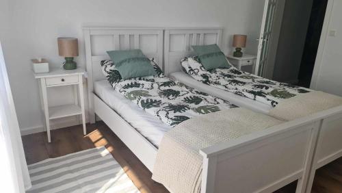 a bedroom with two beds and two night stands at Kavicsház in Vlăhiţa