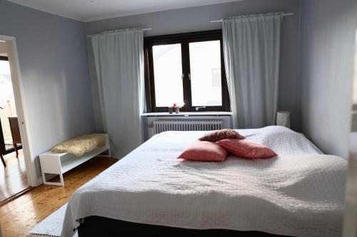 a bedroom with a bed with two pillows on it at Lägenhet nära hav och centrum in Halmstad