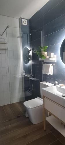 a bathroom with a toilet and a sink at LA Comfy AP in Sarandë