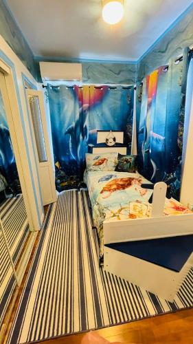 a bedroom with two beds in a room with a mermaid mural at Blue Paradise in Prospect Park