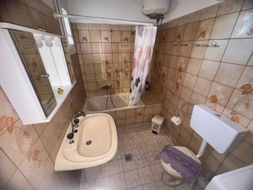 a bathroom with a toilet and a sink and a tub at Alex house Thassos in Skala Sotiros