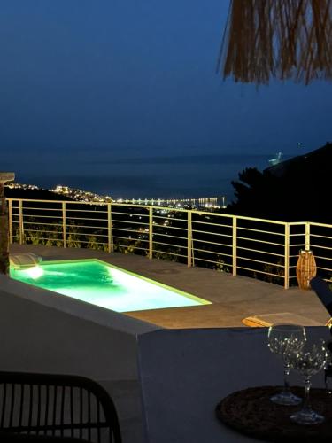 a swimming pool on a balcony at night at Villa Koukounaria in Skopelos Town