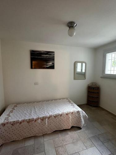 Ένα ή περισσότερα κρεβάτια σε δωμάτιο στο Casa Norma Oasi di pace a un passo dal mare
