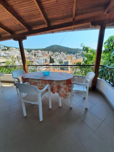 a table and chairs on a balcony with a view at Vasilis Garden House in Kavala