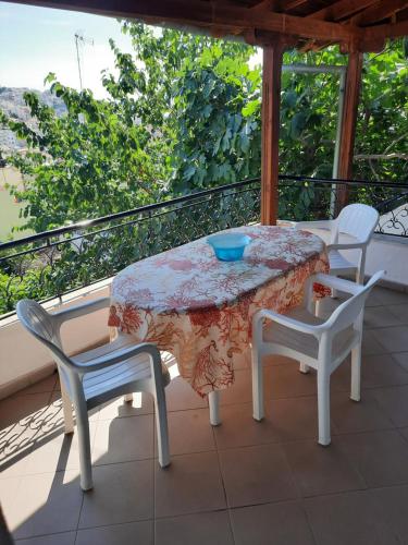 a table and two chairs on a balcony with a table and a table and chairs at Vasilis Garden House in Kavala