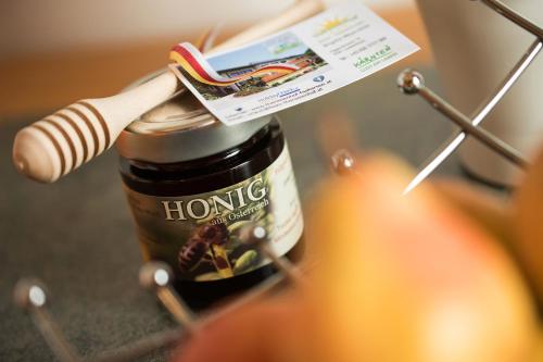 a jar of honey with a label on it at Ferienwohnungen Theresienhof in Ledenitzen