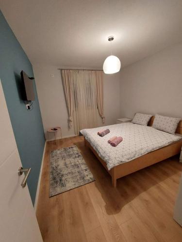 a small bedroom with a bed and a television at VILLA LANA - BLAGAJ in Blagaj
