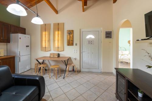 a kitchen and living room with a table and chairs at Spedion Villa - Near to sea villas with heated swimming pool in Gythio