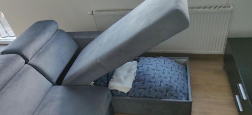 a gray couch with a mattress in a room at Apartament Turysty Zamczysko in Zamość