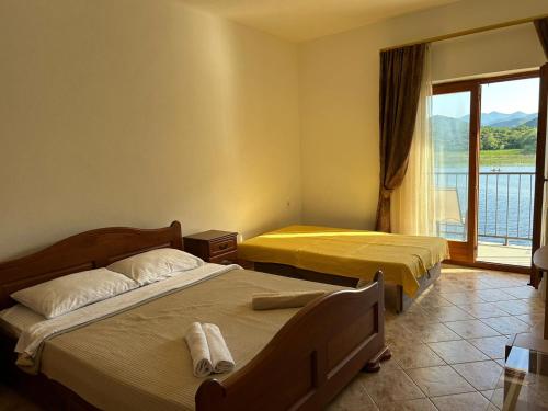a hotel room with two beds and a window at Sunny Terraces in Cetinje