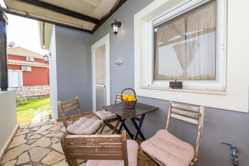 a patio with a table and chairs and a window at Spedion Villa - Near to sea villas with heated swimming pool in Gythio