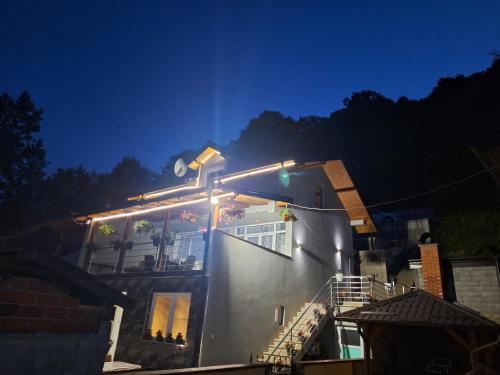 a house with lights on the side of it at Vila Gavrić in Zvornik