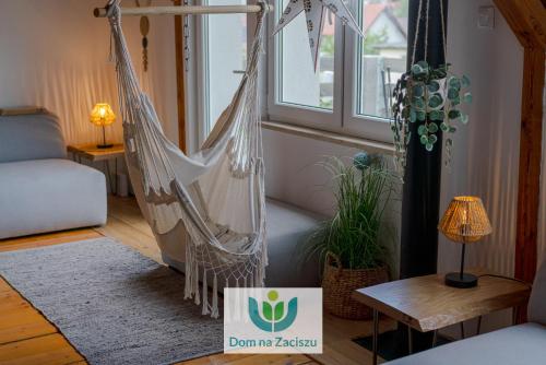 a room with a hammock and a sign that says dont try racism at Dom na Zaciszu Charzykowy in Charzykowy