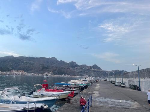 a bunch of boats are docked at a dock at MARIDDA-experience rooms- in Giardini Naxos
