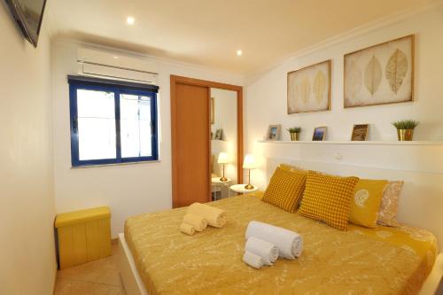 a bedroom with a bed with two pillows on it at Sweethome - Praia da Rocha in Portimão