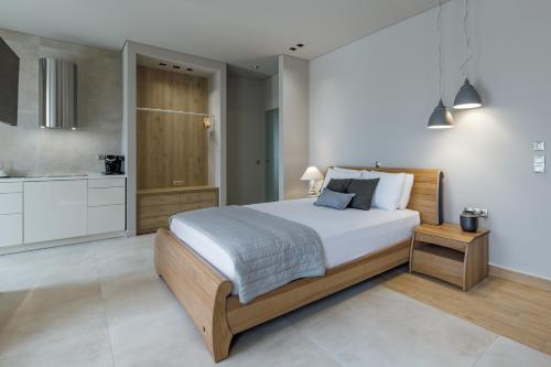 a bedroom with a large bed and a kitchen at El Mar Naxos in Naxos Chora