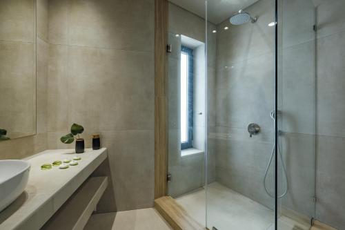 a bathroom with a shower and a sink at El Mar Naxos in Naxos Chora