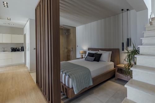 a bedroom with a bed and a staircase in it at El Mar Naxos in Naxos Chora