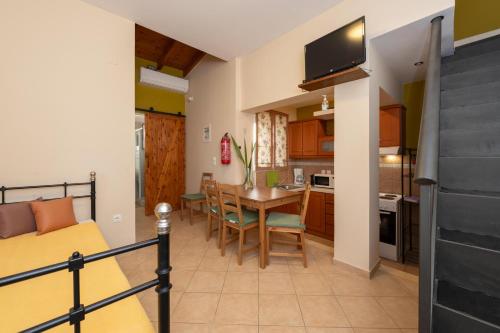 a bedroom with a bed and a kitchen with a table at Spedion Villa - Near to sea villas with heated swimming pool in Gythio