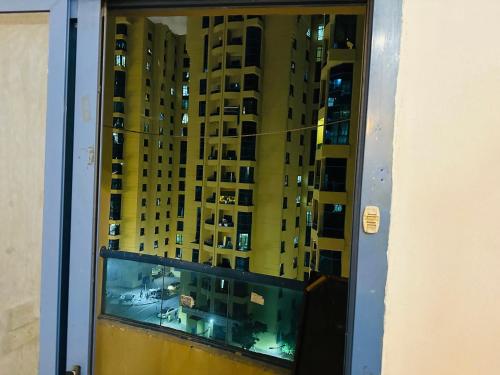 a view of a building from a window at Elite Class Furnished Room in Ajman 