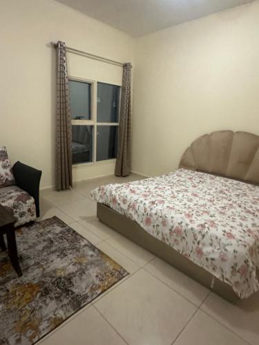 a bedroom with a bed and a window at Elite Class Furnished Room in Ajman 