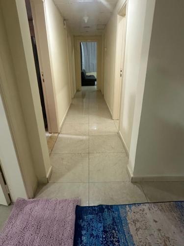 a hallway of a house with a rug on the floor at Elite Class Furnished Room in Ajman 