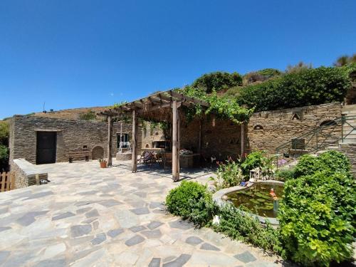 a stone building with a pavilion and a garden at Alexandria Aegean View in Gavrion