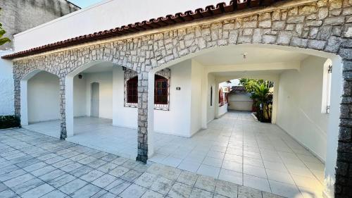 a stone building with an archway in a courtyard at Casa Jardim Colorado in Vila Velha