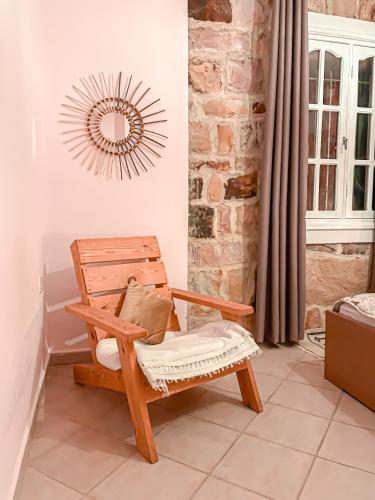 a wooden chair in a room with a mirror at Dar Bakkali Nadi in Tangier