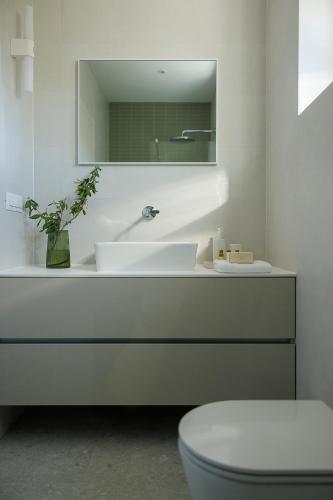 a bathroom with a white sink and a mirror at Villa Olea 2024 Heated Pool -Sauna -400 m beach in Kaštela