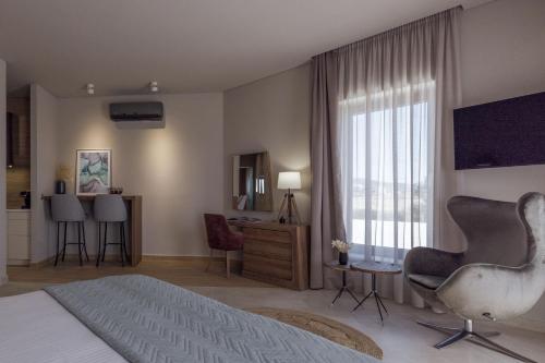 a bedroom with a bed and a large window at El Mar Naxos in Naxos Chora