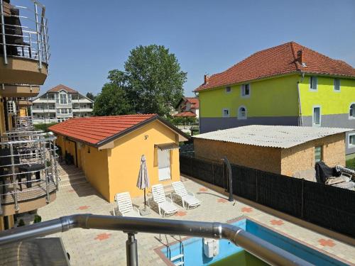 a view of a building with chairs and a pool at Prenociste jezerske zvezde in Veliko Gradište