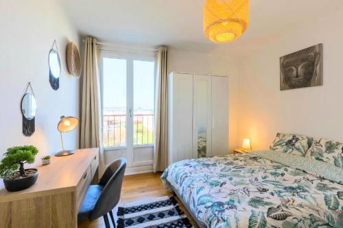 a bedroom with a bed and a desk and a window at Jolie T5 familial 10p in Coulaines