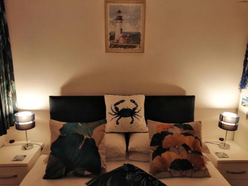 a living room with a bed with pillows and a spider pillow at The Blue Crab in Bournemouth in Bournemouth