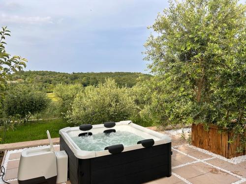 a hot tub sitting on top of a patio at Greenscape Village in Ulcinj