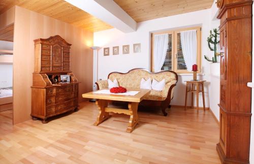 a living room with a couch and a table at Haus König in Bezau