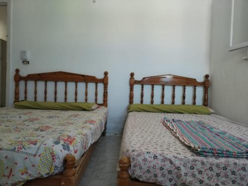two beds sitting next to each other in a room at Ageeba Beach Challet 17 in Marsa Matruh