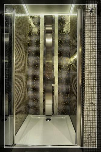 a shower with a glass door in a bathroom at Vision Luxury Apartment Rynek in Wrocław