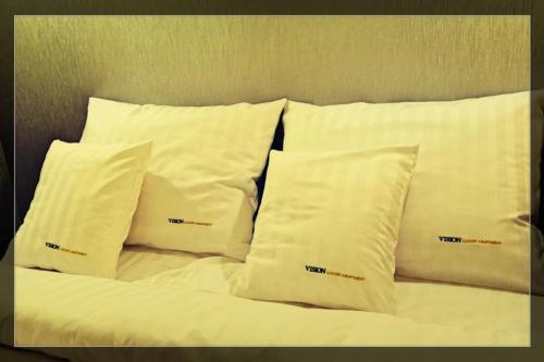 a group of four pillows on a bed at Vision Luxury Apartment Rynek in Wrocław