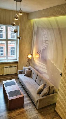 a living room with a couch and a table at Vision Luxury Apartment Rynek in Wrocław