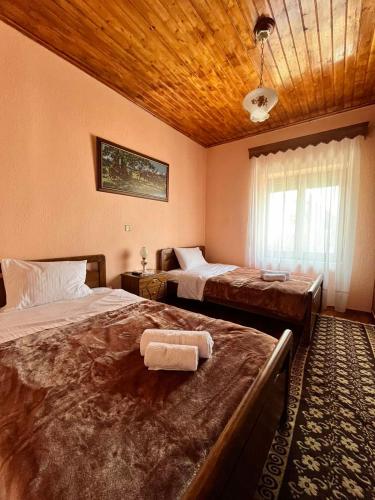 a bedroom with two beds and a wooden ceiling at Rustic House in Miléa