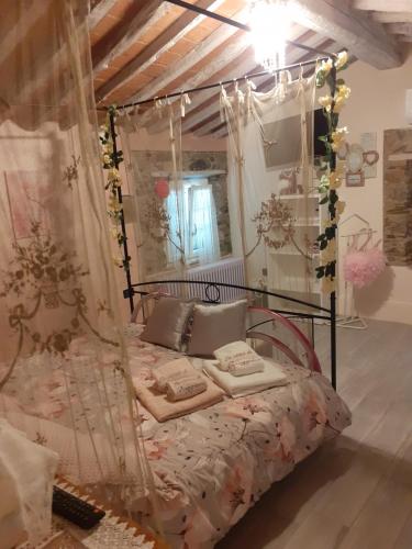 a bedroom with a bed with a canopy at La casa di baggioro in Castelvecchio