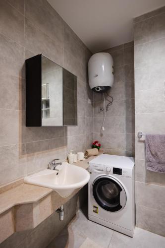 a bathroom with a washing machine and a sink at 2BR Chalet Direct on swimming pool Ain Sokhna in Ain Sokhna
