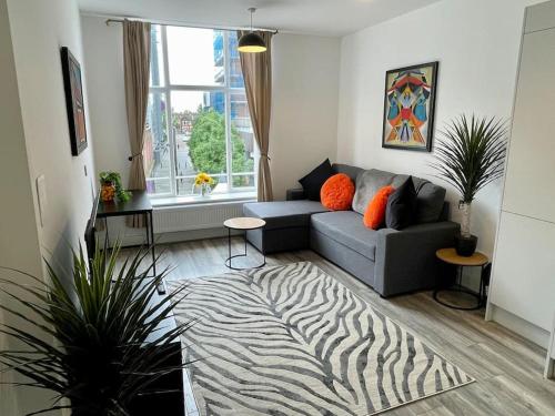a living room with a couch and a zebra rug at Nero view, Southend City High Street in Southend-on-Sea