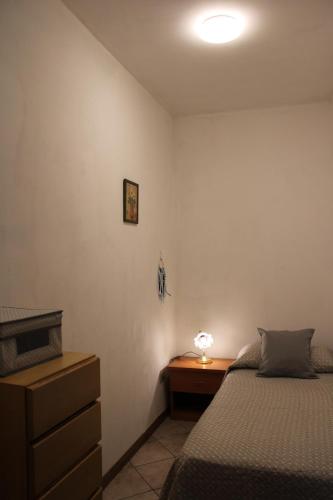 a bedroom with a bed and a desk with a lamp at La Pesciatina in Pescia