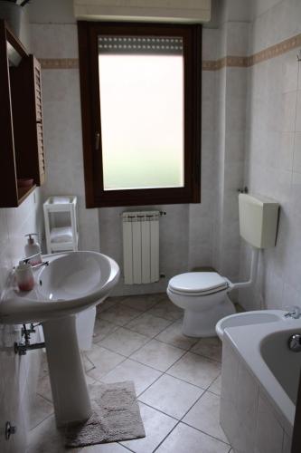 a bathroom with a sink and a toilet and a window at La Pesciatina in Pescia