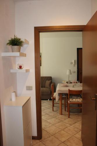 a living room with a table and a dining room at La Pesciatina in Pescia