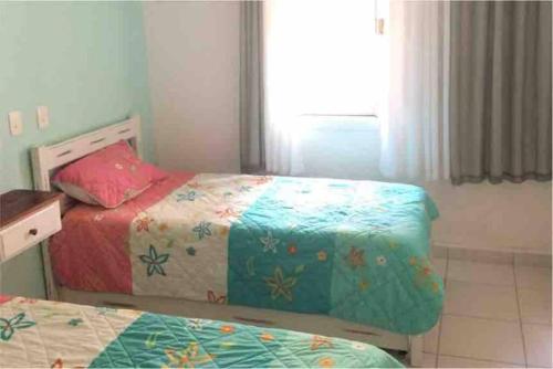 Ένα ή περισσότερα κρεβάτια σε δωμάτιο στο Maresias Cond Club Alto padrão Frente Praia