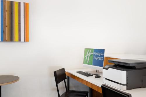 an office with a desk with a computer and a printer at Holiday Inn Express & Suites Spring Hill by IHG in Spring Hill