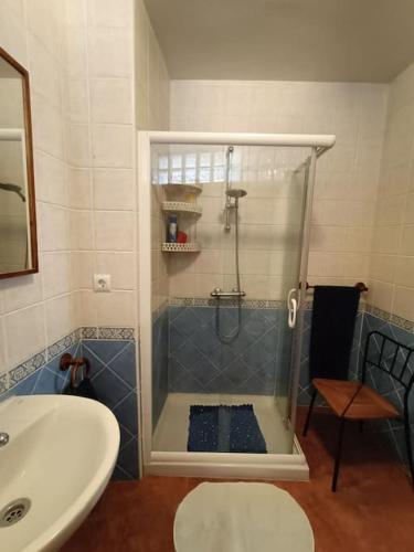 a shower with a glass door in a bathroom at Casa Las Peñuelas in Priego